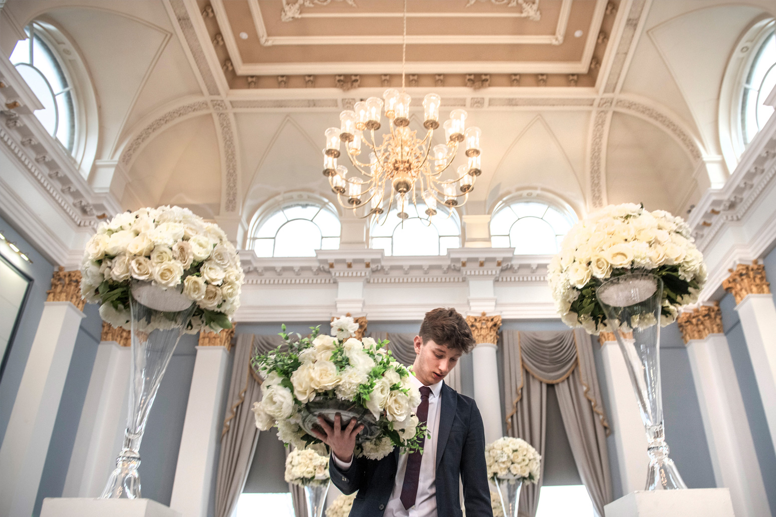 A corn exchange employee sorts flowers.